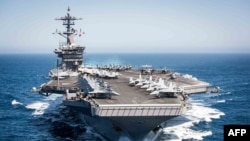 (FILES) This US Navy file handout photo shows the aircraft carrier USS Theodore Roosevelt (CVN 71)as it transits the Pacific Ocean while conducting a tailored ship’s training availability off the coast of Southern California on April 30, 2017. - The…