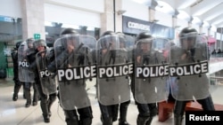 FILE - Riot police prepare to disperse protesters during a rally against Nicaraguan President Daniel Ortega's government, inside Metrocentro mall in Managua, Nicaragua, Feb. 25, 2020.