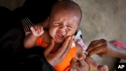 FILE - A Somali baby cries while receiving a five-in-one vaccine against several potentially fatal childhood diseases, at the Medina Maternal Child Health center in Mogadishu, Somalia 