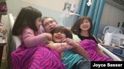 Joyce Sasser enjoys a 2016 hospital visit from her grandchildren. Today, she is out of the hospital and in good health. (Photo courtesy: Joyce Sasser)