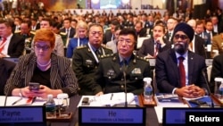 Australia's Defense Minister Marise Payne, from left, China's PLA Lieutenant-General He Lei and Canada's Defense Minister Harjit Sajjan listens to U.S. Secretary of Defense Jim Mattis' address at the Shangri-la Dialogue in Singapore, June 2, 2018.
