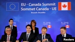 (L-R) European Commission President Jean-Claude Juncker, Canada's Prime Minister Justin Trudeau, European Council President Donald Tusk and Slovakia's Prime Minister Robert Fico attend the signing ceremony of the Comprehensive Economic and Trade Agreement