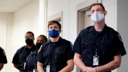 In this Sept. 9, 2020, photo Zachary Ruhling, center, a training police officer in the Baltimore Police Academy, watches a video presentation during a class on justice in Baltimore. (AP Photo/Julio Cortez)