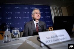 FILE - Joji Morishita, Japan's commissioner to the International Whaling Commission (IWC), looks at his computer during a press conference in Tokyo, Nov. 28, 2014.