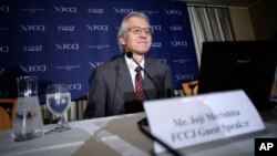 FILE - Joji Morishita, Japan's commissioner to the International Whaling Commission (IWC), looks at his computer during a press conference in Tokyo, Nov. 28, 2014.