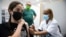 An Israeli youth receives a Pfizer-BioNTech COVID-19 vaccine in the central Israeli city of Rishon LeZion, June 6, 2021. 
