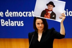 FILE - Belarusian opposition politician Sviatlana Tsikhanouskaya holds a picture of Belarusian opposition activist Nina Baginskaya as she speaks during the Sakharov Prize ceremony at the European Parliament in Brussels, Dec. 16, 2020.
