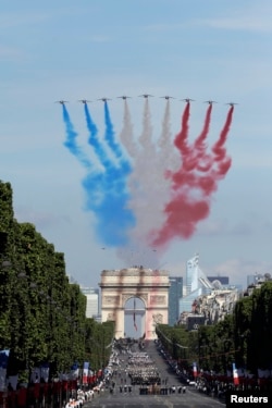 French Alphajets of the Patrouille de France fly over the Champs Elysees avenue, with the Arc de Triomphe in background, during the Bastille Day parade in Paris, July 14, 2017.