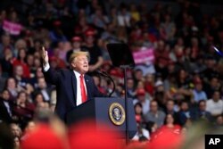 FILE - President Donald Trump speaks at a campaign rally in Grand Rapids, Michigan, March 28, 2019.