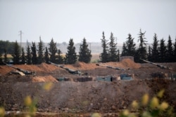 Artillery pieces are seen on the Turkish side of the border with Syria near Akcakale in Sanliurfa province, Oct. 8, 2019.