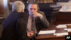 Kansas Senate President Ty Masterson, right, R-Andover, confers with Senate Majority Leader Larry Alley, left, R-Winfield, ahead of a Senate vote on overriding Gov. Laura Kelly's veto of a bill banning transgender athletes from girl's and women's sports, April 5, 2023, in Topeka, Kansas.