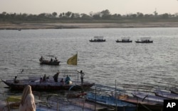 Indians ride on boats in the River Ganges, in Allahabad, March 21, 2017.