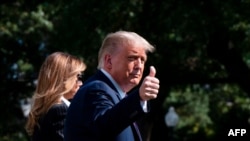 US President Donald Trump and First Lady Melania Trump walk to Marine One to depart from the South Lawn of the White House in Washington, DC, on Sept. 29, 2020.