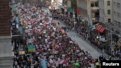 People walk down Sixth Avenue as they participate in the Women's March in Manhattan, New York City, Jan. 20, 2018.