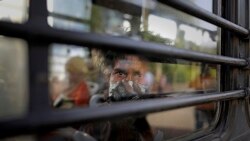 An Indian homeless man sits in a bus as he is being evicted with other homeless people and migrant laborers from the banks of Yamuna River where they have been squatting during lockdown in New Delhi, India, April 15, 2020.