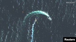 A satellite image shows a Serna-class landing craft and possible missile contrail near Snake Island