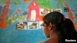 FILE - A 16-year-old girl stands inside a protection home on the outskirts of New Delhi. She was working as a maid and was later rescued by Bachpan Bachao Andolan (Save the Childhood Movement), a charity that rescues victims of bonded labor.