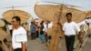 Cambodian people hold their kites before their kite flying at an annual traditional kite flying event in Phnom Penh, Cambodia, Friday, Dec. 5, 2008. Kite flying was one of the royal "ceremonies of the twelve months", according a National Kite Museum. (AP Photo/Heng Sinith)