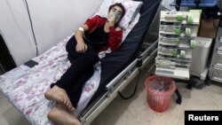 A civilian breathes through an oxygen mask at al-Quds hospital after an alleged chlorine gas attack alongside barrel bombs on a neighborhood of Aleppo, Syria, Aug. 11, 2016.