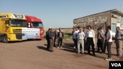 In this image sent to VOA by an Iranian social media user, Iranian truck owners and drivers stage a strike on May 22, 2018, with a sign on their vehicles saying they are upset about increasing costs of road tolls and spare parts while salaries remain stagnant.