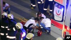 Des équipes de secours aident un blessé à l'extérieur de l'aéroport d'Istanbul, Turquie, le 28 juin 2016.