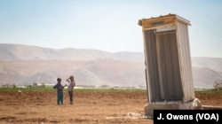 A UNHCR toilet stands solitary in what used to be a refugee camp. The recent eviction notice has affected between 8000 and 12000 refugees in Lebanon's Bekaa Valley.