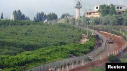 Israeli forces patrol the border with Lebanon, near Kfar Kila, Lebanon, May 9, 2018. 