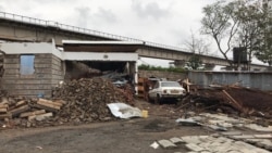 Mary Abuto's home is in ruins. She lost her home and more than half of her land she'd purchased in more than 20 years. She was one of the few who were compensated for the damage. (M.Yusuf/VOA)