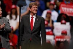 FILE - U.S. Rep. Scott Tipton, R-Colo., listens as President Donald Trump speaks at a campaign rally in Colorado Springs, Colo., Feb. 20, 2020.