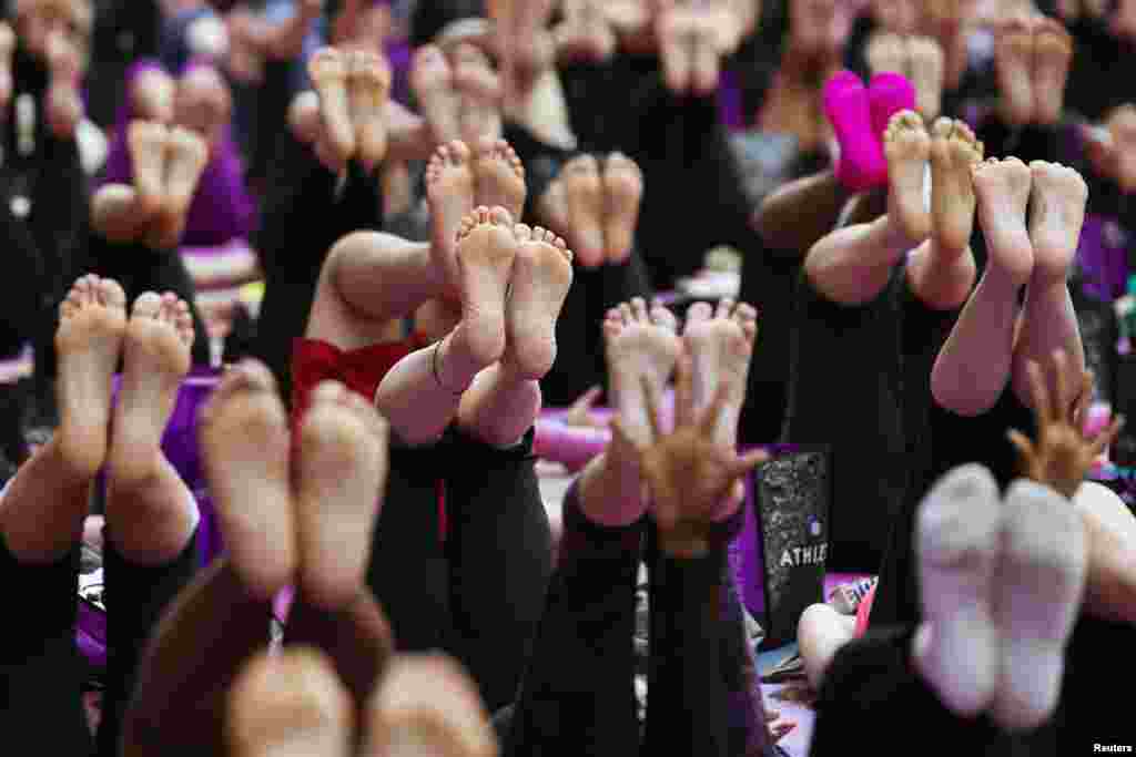 Sejumlah orang ambil bagian dalam sebuah latihan yoga pada pagi hari bertepatan dengan awal musim panas di New York Times Square. Acara &#39;Solstice di Times Square&#39; mengajak ribuan pesertanya untuk memperingatihari terpanjang dalam tahun ini. 