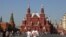 FILE - People walk in Red Square near the State Historical Museum and the Kremlin wall in central Moscow, Sept. 10, 2024. 