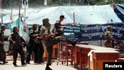 Cambodian riot police move in to break up an opposition sit-down protest outside the Cambodian parliament September 8, 1998. The protest, organised by opposition parties protesting the result of the July 26 election, began on August 24 and was broken up by police using water-canon. (Reuters)