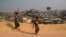Rohingya refugees carry a hume pipe in Balukhali refugee camp near Cox's Bazar, in Bangladesh, Nov. 17, 2018. 