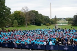 A crowd of President Donald Trump's supporters gather on the South Lawn to listen to him speak, Oct. 10, 2020, in Washington.