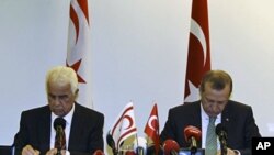 Turkish PM Recep Tayyip Erdogan and Turkish Cypriot Leader Dervish Eroglu (L) attend a signing ceremony in New York on September 21, 2011 for a deal for offshore gas exploration in the Mediterranean