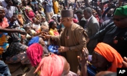 At the internal displaced camp in Bokkos, Nigeria, on Dec. 27, 2023, Vice President Kashim Shettima shakes hands with survivors of the attacks that killed at least 150 people.