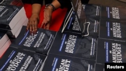 U.S. Government Publishing Office employee Darlene Matthews arranges new copies of President Donald Trump's Budget for the U.S. Government for the Fiscal Year 2019 at the U.S. Government Publishing Office in Washington, Feb. 12, 2018.