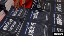U.S. Government Publishing Office employee Darlene Matthews arranges new copies of President Donald Trump's Budget for the U.S. Government for the Fiscal Year 2019 at the U.S. Government Publishing Office in Washington, U.S., Feb. 12, 2018.