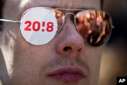A logo of Russian opposition leader Alexei Navalny's presidential campaign is sticked on demonstrator Ivan Egorov's glasses, as he attends an opposition rally in Moscow, Russia, May 6, 2017.