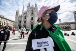 People stage a protest against government and for work rights in front of the Duomo gothic cathedral, in Milan, Italy, May 4, 2020.