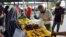 A man selects fresh produce at a mobile food bank run by Kechara in Kuala Lumpur. (Zsombor Peter/VOA)