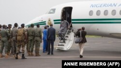Les chefs militaires maliens saluent l'ancien président nigérian Goodluck Jonathan à son arrivée à l'aéroport de Bamako avant une rencontre entre les chefs militaires maliens et une délégation de la CEDEAO qu'il dirige le 22 août 2020.
