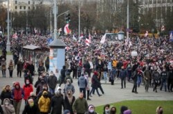 FILE - Belarusian opposition supporters walk during a rally to reject the presidential election results in Minsk, Belarus, Nov. 1, 2020.