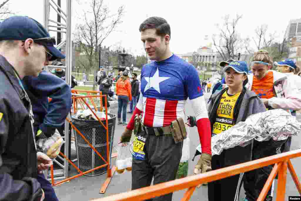Marathon participant Christopher Snedecor of Somerville, MA goes through security as he arrives at the Boston Commons to board a bus that will bring him to the marathon starting line in Hopkinton, April 20, 2015.