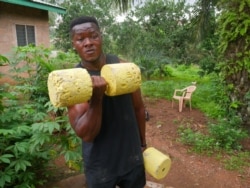 Bodybuilder Samuel Kulbila has gained an international following from posting videos of workouts done with improvised equipment, like concrete weights. Accra, Ghana, July 5, 2020. (Stacey Knott/VOA)