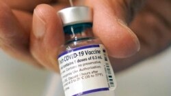 FILE - A doctor loads a dose of Pfizer COVID-19 vaccine into a syringe, Dec. 2, 2021, at a mobile vaccination clinic in Worcester, Mass. The Pfizer-BioNTech vaccine is the sole option for children in the U.S.