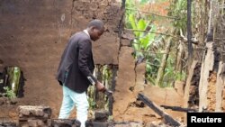 Kasereka Deogracias, kepala Desa Kasambirio, memeriksa rumah yang hancur akibat serangan pemberontak Islamis ADF di Desa Mukondi, selatan Beni, Republik Demokratik Kongo, 10 Maret 2023. ADF menyerang Desa Musandaba pada Sabtu, 8 April 2023. (Foto: Erikas Mwisi Kambale/Reuters)