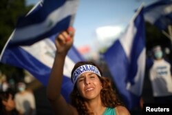A demonstrator cries as she sings a song during a protest in Managua, Nicaragua, June 18, 2018.