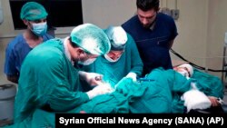 A victim who was injured by shelling in the town of Suqailabiyah, receives treatment at a hospital in central city of Hama, Syria, May 12, 2019. 