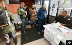 Voters check in at a polling station for Massachusetts' primary election in the East Boston neighborhood of Boston, March 1, 2016.